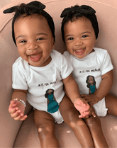 Two little girls are wearing comfortable baby bows from By Bella Boutique.